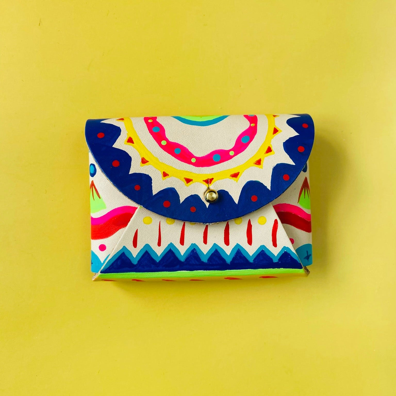 Colorful patterned wallet on a yellow background