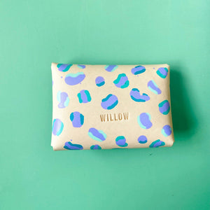 Rectangular pouch with blue and green abstract pattern on a light green background