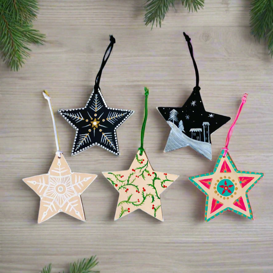 Five star-shaped Christmas ornaments on a white background